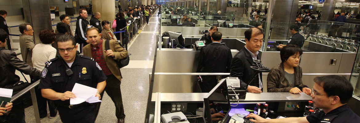 travelers entering customs at airport